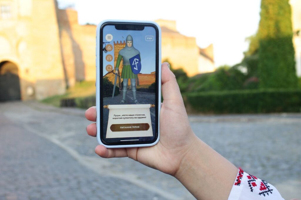 Smartfon w dłoni, aplikacja historyczna